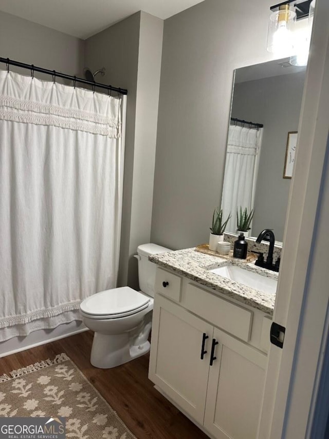 20 Wagon Trl, Mansfield, GA 30055 - full bathroom with vanity, wood finished floors, shower / bath combination with curtain, and toilet