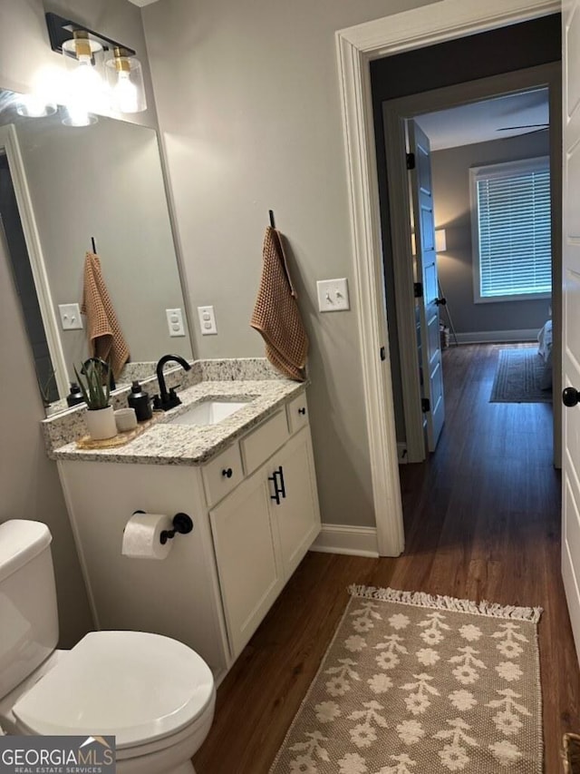 20 Wagon Trl, Mansfield, GA 30055 - half bathroom featuring toilet, baseboards, wood finished floors, and vanity