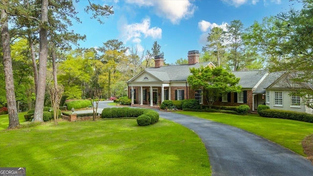 2727 Ingleside Ave, Macon, GA 31204 - neoclassical / greek revival house featuring a chimney, brick siding, and a front yard