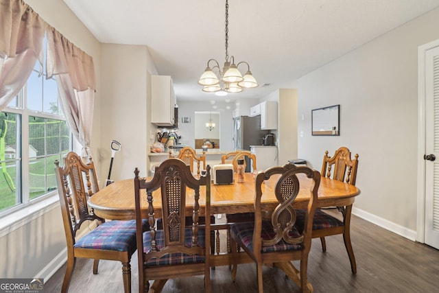 4015 Soaring Dr, Douglasville, GA 30135 - dining room featuring baseboards, dark wood-style floors, and a chandelier