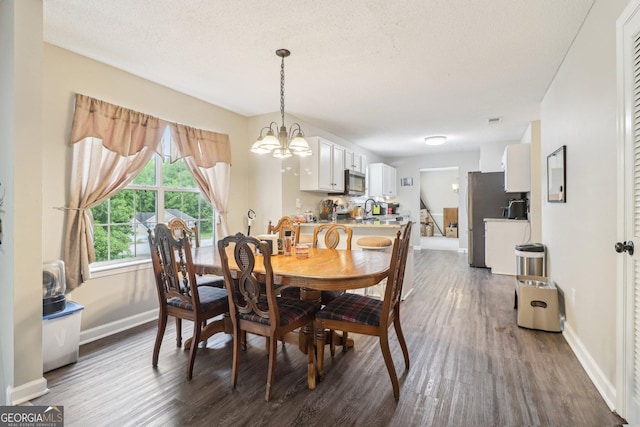 4015 Soaring Dr, Douglasville, GA 30135 - dining space featuring a textured ceiling, baseboards, a chandelier, and dark wood finished floors