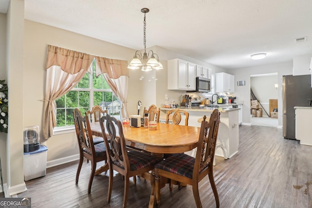 4015 Soaring Dr, Douglasville, GA 30135 - dining room featuring visible vents, baseboards, a notable chandelier, and dark wood-style floors
