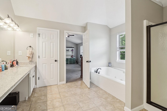 4015 Soaring Dr, Douglasville, GA 30135 - bathroom featuring a garden tub, tile patterned flooring, a shower stall, vaulted ceiling, and vanity