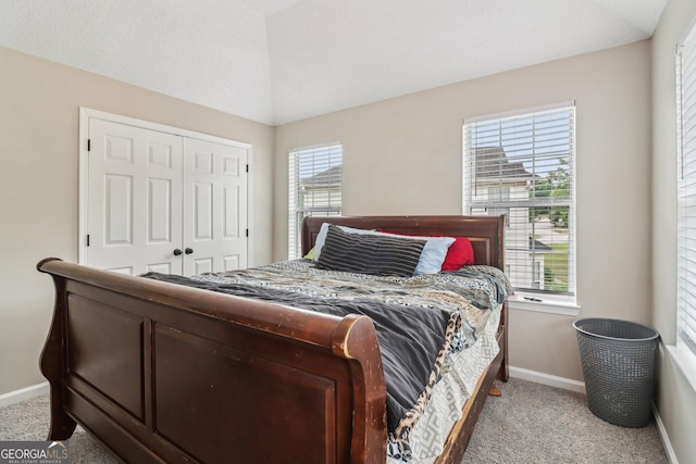 4015 Soaring Dr, Douglasville, GA 30135 - carpeted bedroom featuring baseboards, a closet, and lofted ceiling