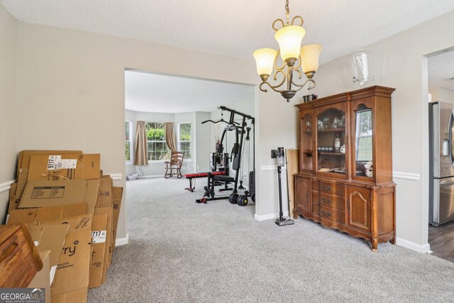 4015 Soaring Dr, Douglasville, GA 30135 - exercise area with carpet floors, baseboards, and a chandelier