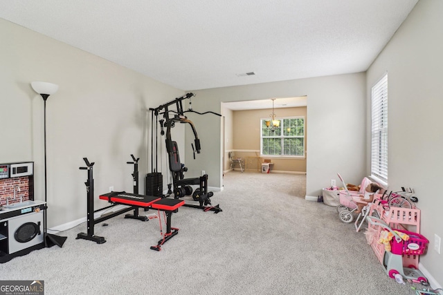 4015 Soaring Dr, Douglasville, GA 30135 - workout room with visible vents, carpet flooring, baseboards, and an inviting chandelier
