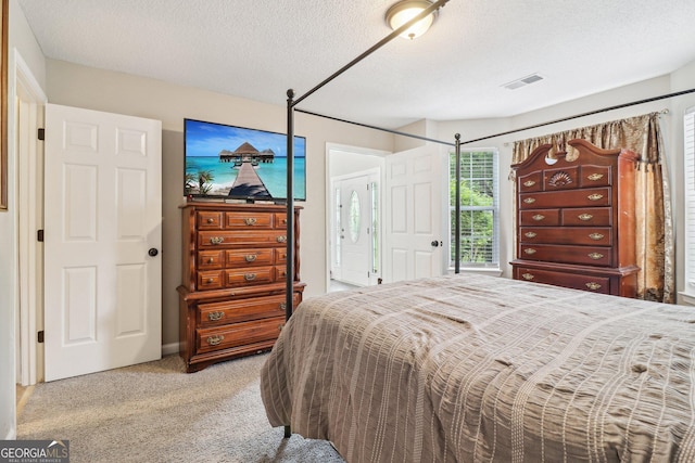 4015 Soaring Dr, Douglasville, GA 30135 - bedroom with light colored carpet, a textured ceiling, and visible vents