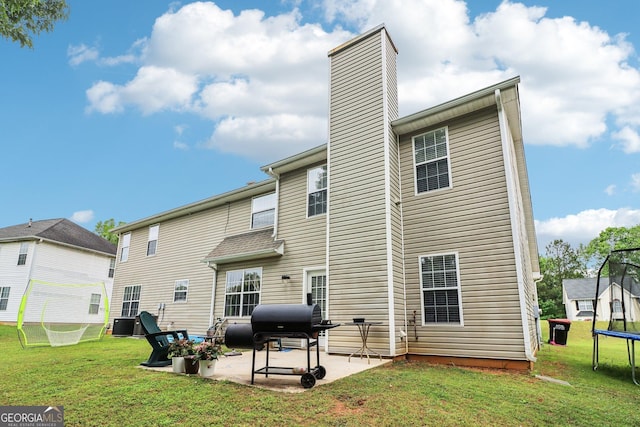 4015 Soaring Dr, Douglasville, GA 30135 - back of property featuring a chimney, a trampoline, a patio area, central AC, and a yard