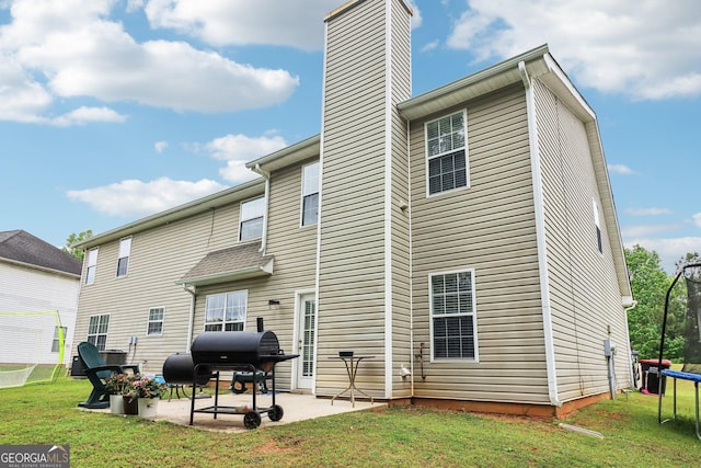 4015 Soaring Dr, Douglasville, GA 30135 - back of property with a chimney, a yard, and a patio area