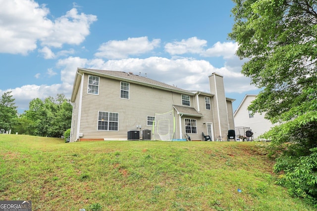 4015 Soaring Dr, Douglasville, GA 30135 - back of property with a yard, central AC unit, and a chimney