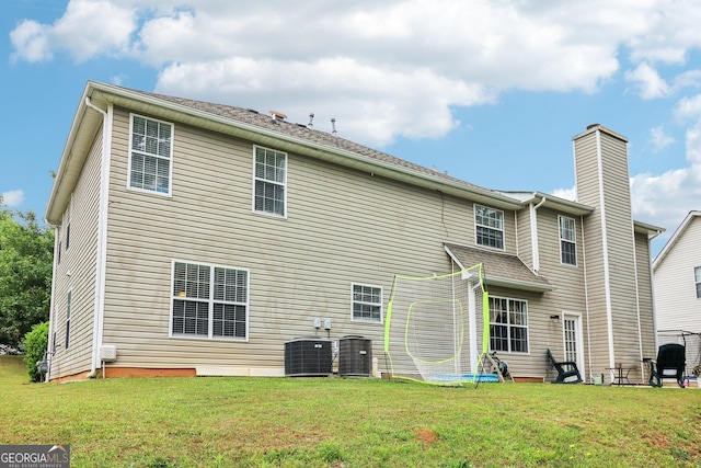 4015 Soaring Dr, Douglasville, GA 30135 - rear view of property featuring a lawn, a chimney, and cooling unit