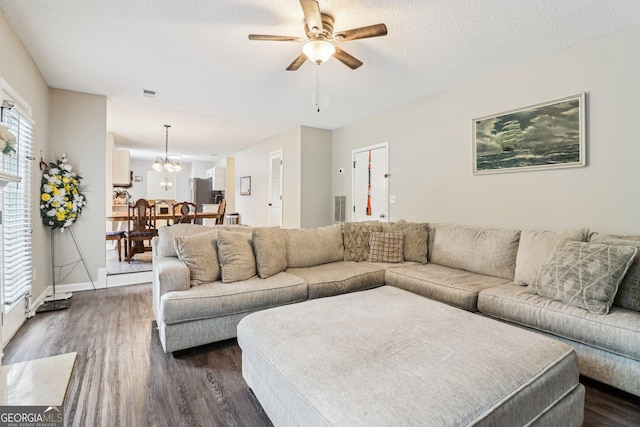 4015 Soaring Dr, Douglasville, GA 30135 - living room featuring dark wood-type flooring, baseboards, ceiling fan with notable chandelier, and visible vents