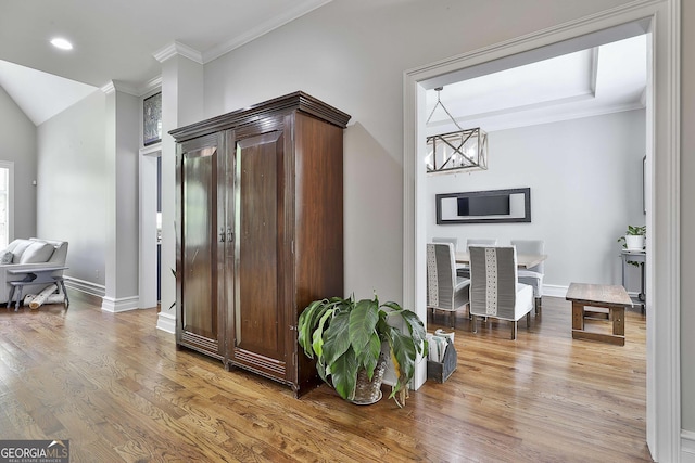 hallway with crown molding, a chandelier, recessed lighting, baseboards, and wood finished floors