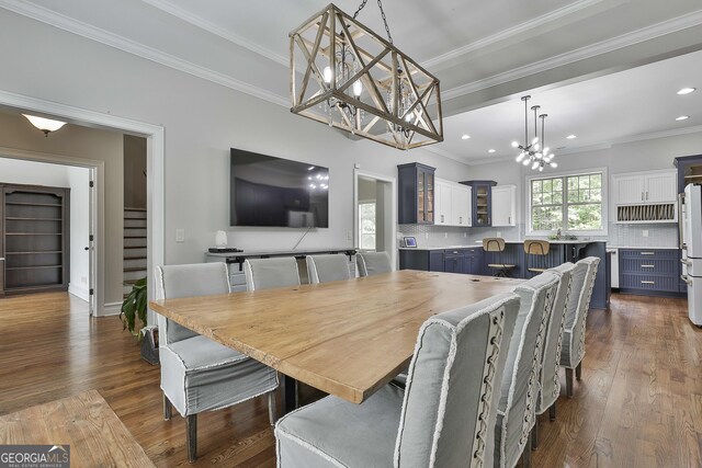 dining space with an inviting chandelier, ornamental molding, dark wood-style floors, stairway, and recessed lighting