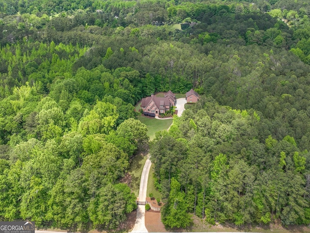 birds eye view of property with a forest view