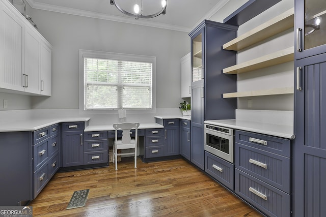 kitchen featuring ornamental molding, white cabinets, blue cabinets, and visible vents