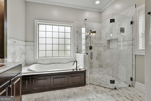 full bath featuring crown molding, a marble finish shower, a bath, and vanity
