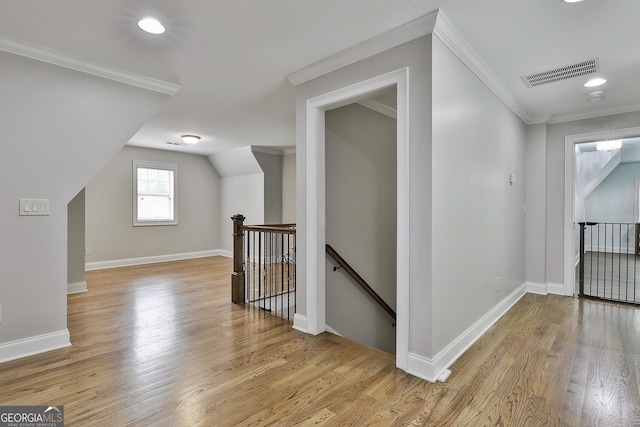 bonus room with baseboards, light wood finished floors, and visible vents