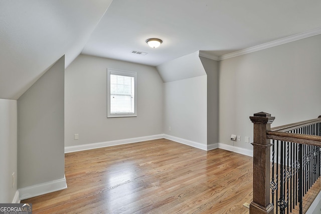 additional living space featuring vaulted ceiling, visible vents, baseboards, and light wood finished floors