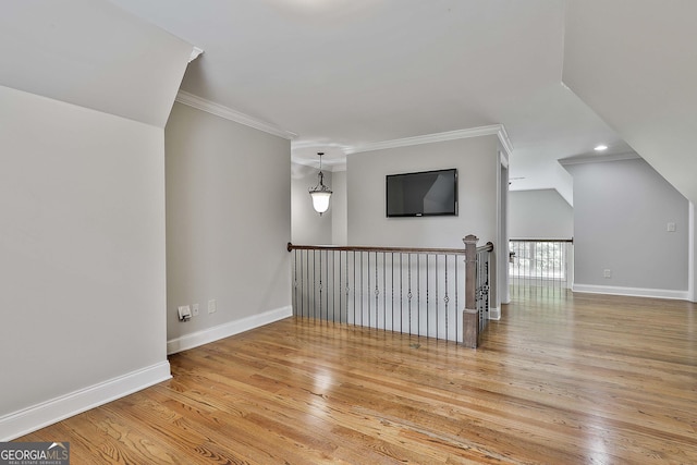 additional living space with light wood-type flooring and baseboards