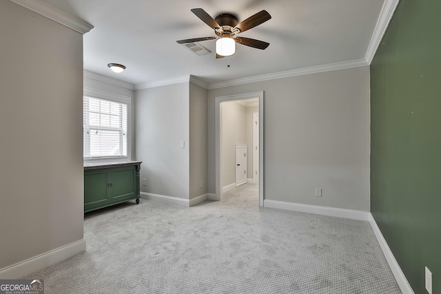 unfurnished bedroom with crown molding, baseboards, light carpet, and visible vents