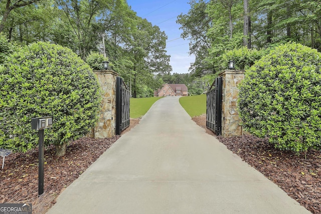 view of gate with a yard