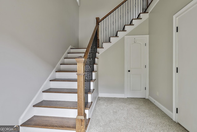 stairway with carpet flooring and baseboards