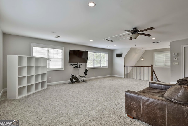 carpeted living area featuring visible vents, a ceiling fan, and baseboards
