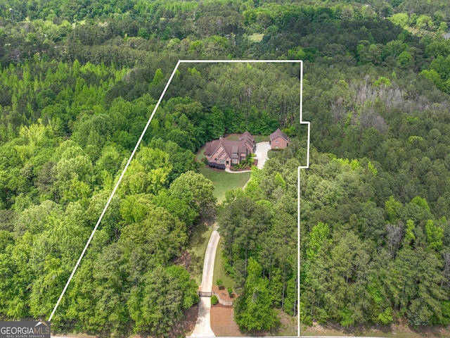 drone / aerial view featuring a wooded view