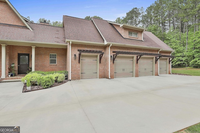 view of front of home featuring concrete driveway, brick siding, and an attached garage