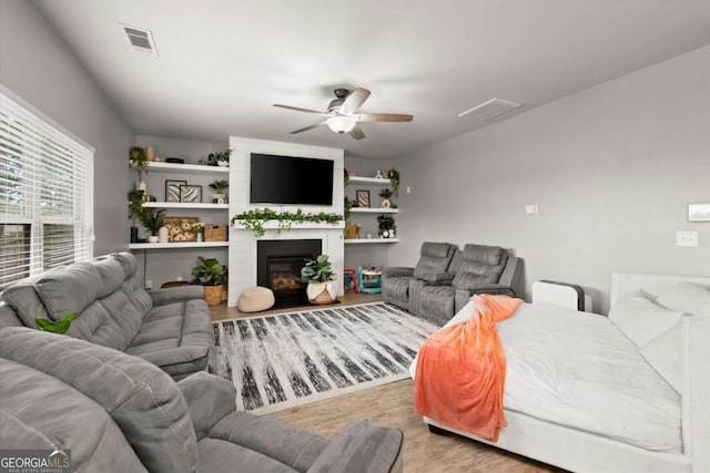 188 Lookout Way, Dallas, GA 30132 - living area featuring ceiling fan, a fireplace, wood finished floors, and visible vents