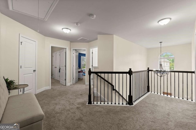 188 Lookout Way, Dallas, GA 30132 - hallway featuring baseboards, attic access, a chandelier, carpet flooring, and an upstairs landing