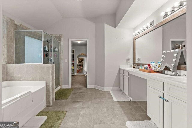 188 Lookout Way, Dallas, GA 30132 - full bathroom featuring double vanity, a walk in closet, a bath, a shower stall, and a sink