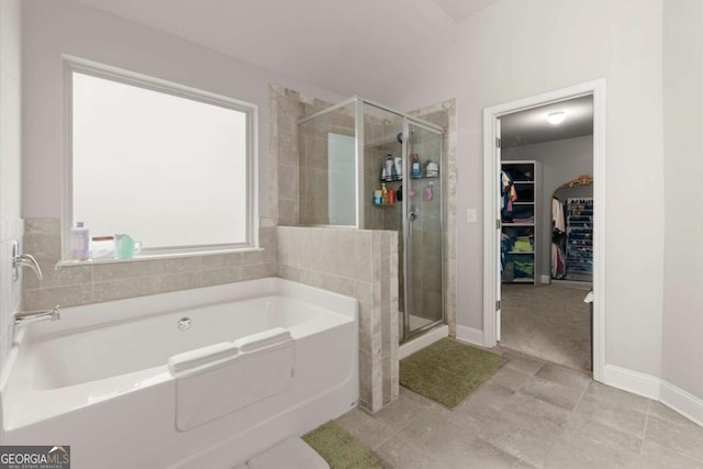 188 Lookout Way, Dallas, GA 30132 - full bath featuring tile patterned floors, baseboards, a spacious closet, a garden tub, and a stall shower