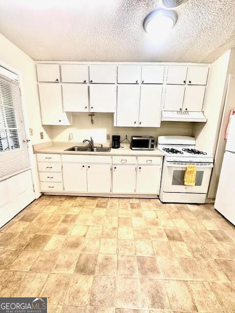 135 E Hill St Unit 12, Decatur, GA 30030 - kitchen with a sink, under cabinet range hood, white appliances, and light countertops