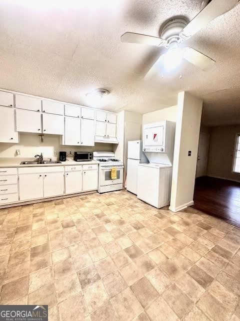 135 E Hill St Unit 12, Decatur, GA 30030 - kitchen with a sink, white appliances, a textured ceiling, white cabinetry, and under cabinet range hood