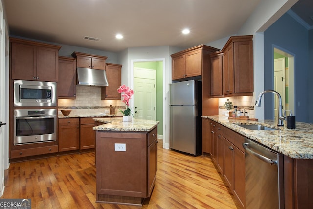 3508 Blue Spruce Ct SW, Gainesville, GA 30504 - kitchen featuring appliances with stainless steel finishes, under cabinet range hood, a sink, light wood-type flooring, and recessed lighting