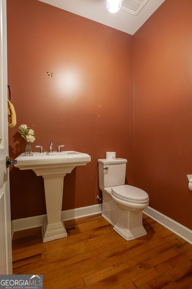 3508 Blue Spruce Ct SW, Gainesville, GA 30504 - bathroom with wood finished floors, toilet, and baseboards
