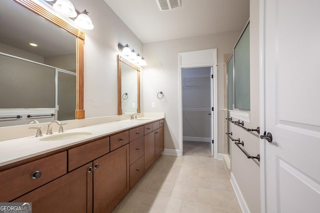 3508 Blue Spruce Ct SW, Gainesville, GA 30504 - full bathroom with double vanity, a shower stall, a spacious closet, baseboards, and tile patterned floors