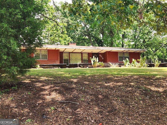 3976 Mosley Dr, Columbus, GA 31903 - ranch-style house with brick siding, a chimney, and a front yard