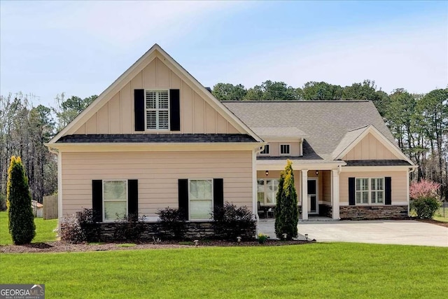 craftsman-style house featuring a front lawn, board and batten siding, roof with shingles, and stone siding