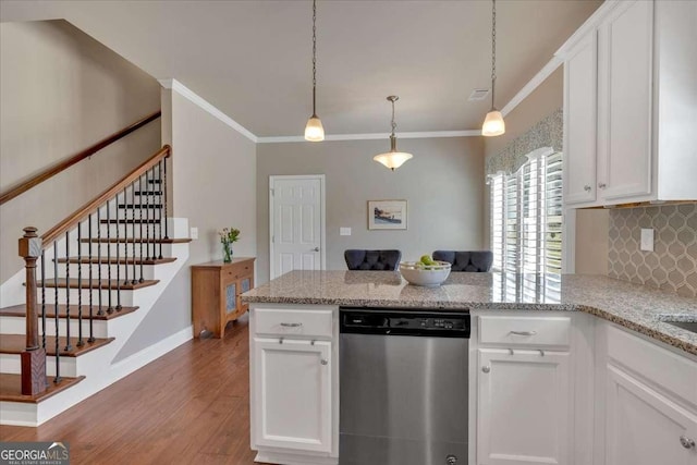 kitchen with white cabinets, a peninsula, decorative backsplash, light wood-type flooring, and stainless steel dishwasher