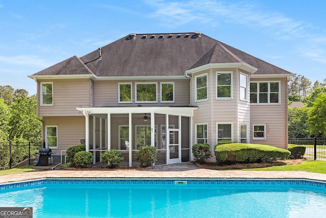 679 Gold Valley Pass, Canton, GA 30114 - rear view of house with fence, a sunroom, a ceiling fan, a fenced in pool, and a shingled roof
