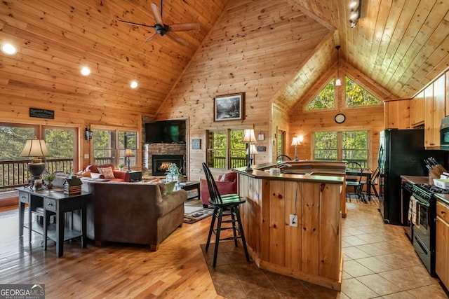 433 Spruce Cir, Mineral Bluff, GA 30559 - kitchen featuring wood ceiling, black range with gas cooktop, ceiling fan, dark countertops, and high vaulted ceiling