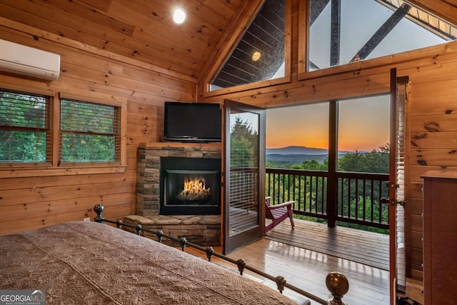 433 Spruce Cir, Mineral Bluff, GA 30559 - bedroom with wooden walls, an AC wall unit, access to exterior, wood finished floors, and vaulted ceiling