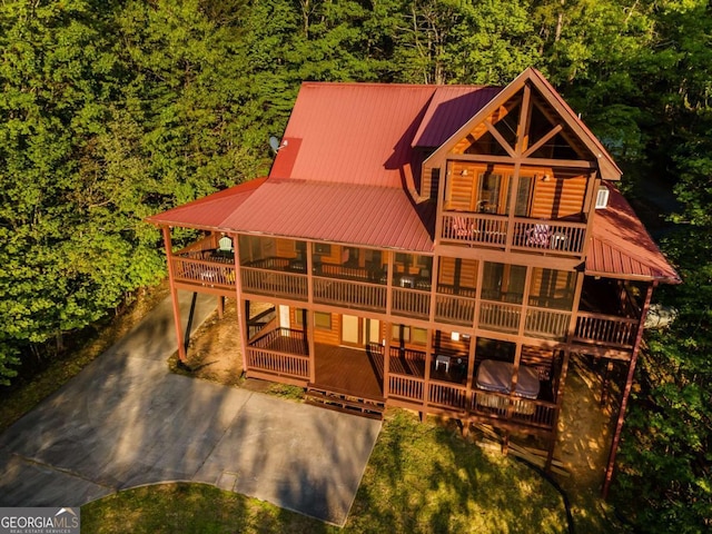 433 Spruce Cir, Mineral Bluff, GA 30559 - back of property with metal roof, a deck, a view of trees, a balcony, and concrete driveway