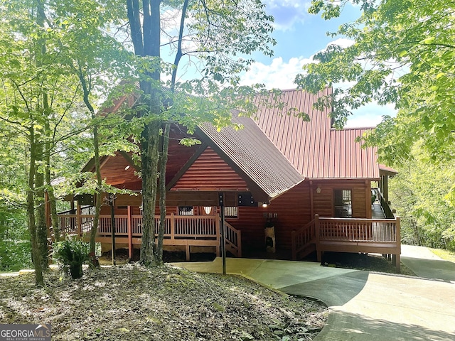 433 Spruce Cir, Mineral Bluff, GA 30559 - rear view of house featuring faux log siding, a porch, and metal roof