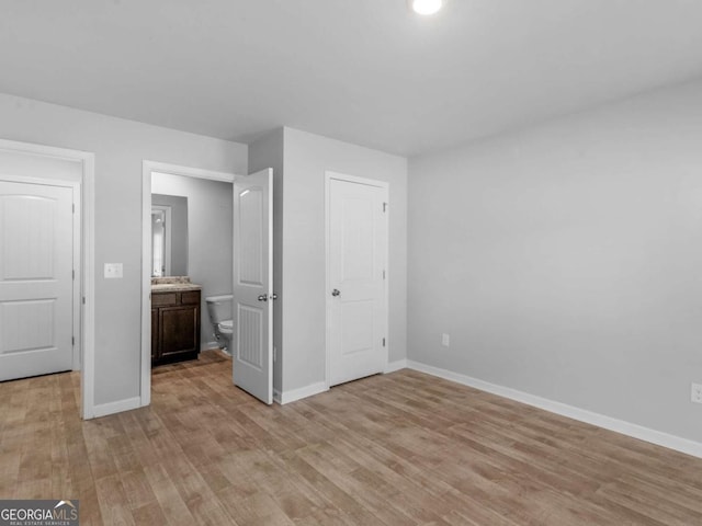 unfurnished bedroom with baseboards and light wood finished floors