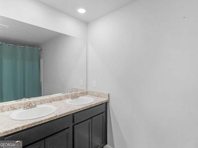 bathroom featuring double vanity and a sink