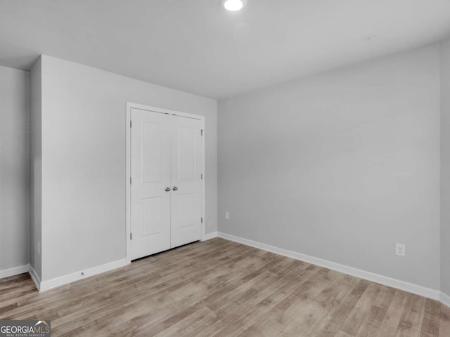 unfurnished room featuring recessed lighting, baseboards, and light wood finished floors
